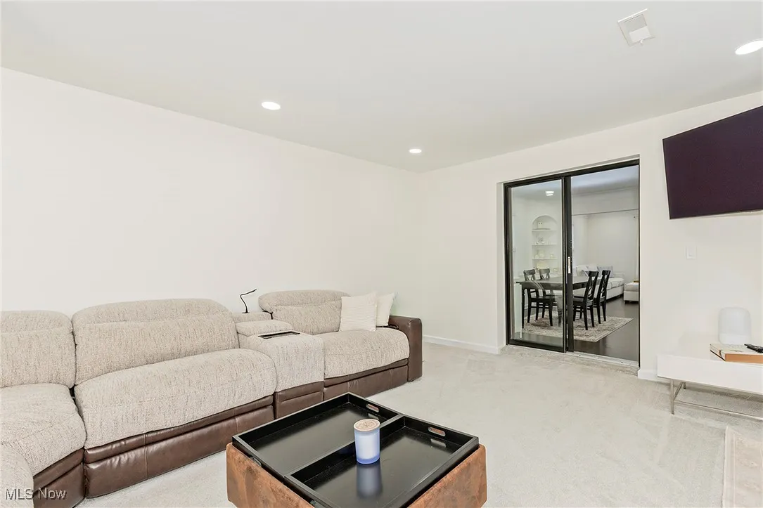 A clean family room with recessed lighting, perfect for relaxation and entertainment.