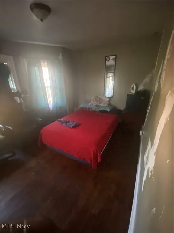 Bedroom with wood finished floors and pool table