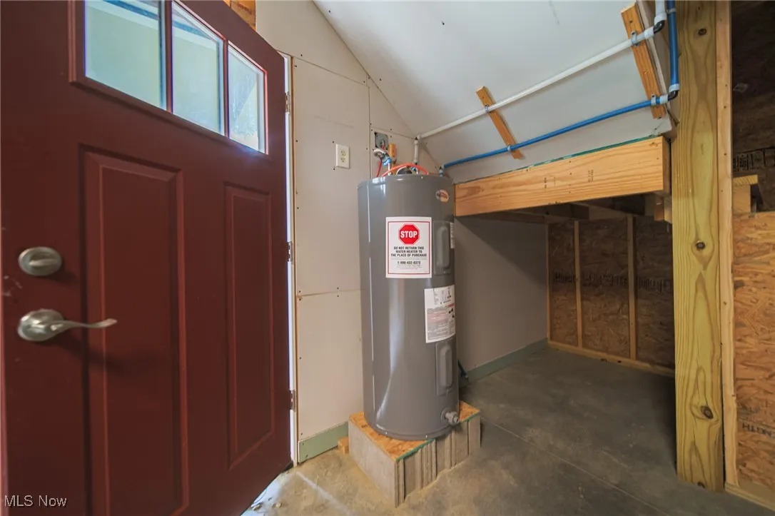 Utility room featuring electric water heater