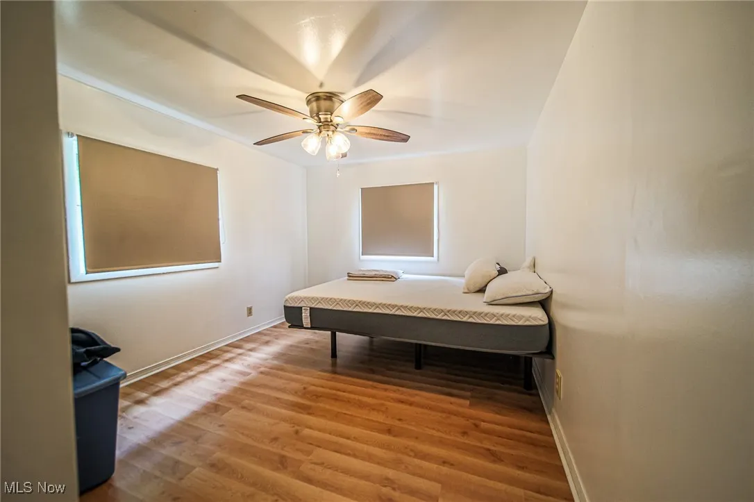 Bedroom featuring wood finished floors and ceiling fan