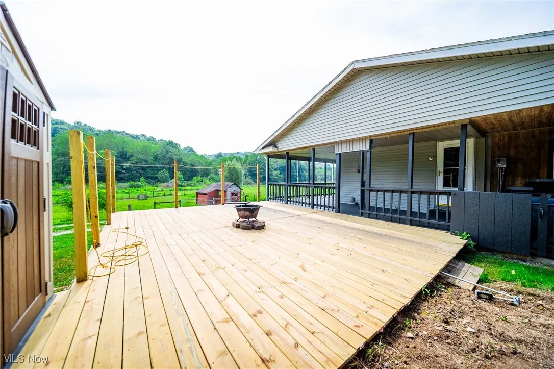 Wooden deck featuring an outdoor fire pit