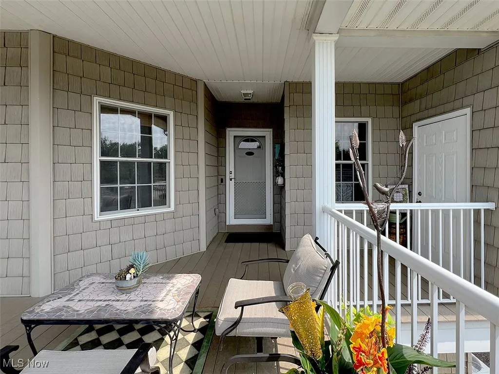 Front doorway to featuring a porch
