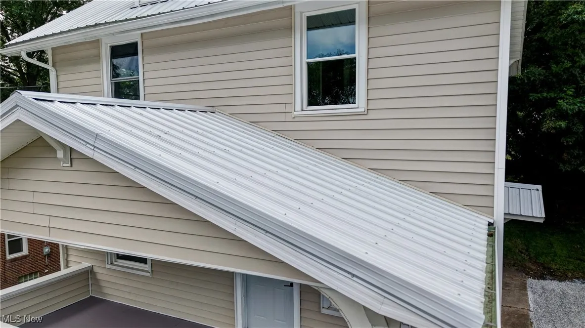View of side of property with a metal roof