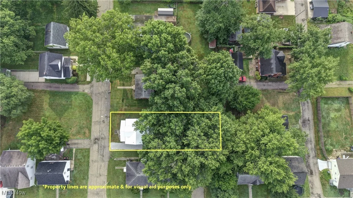 Aerial perspective of suburban area featuring property boundaries highlighted