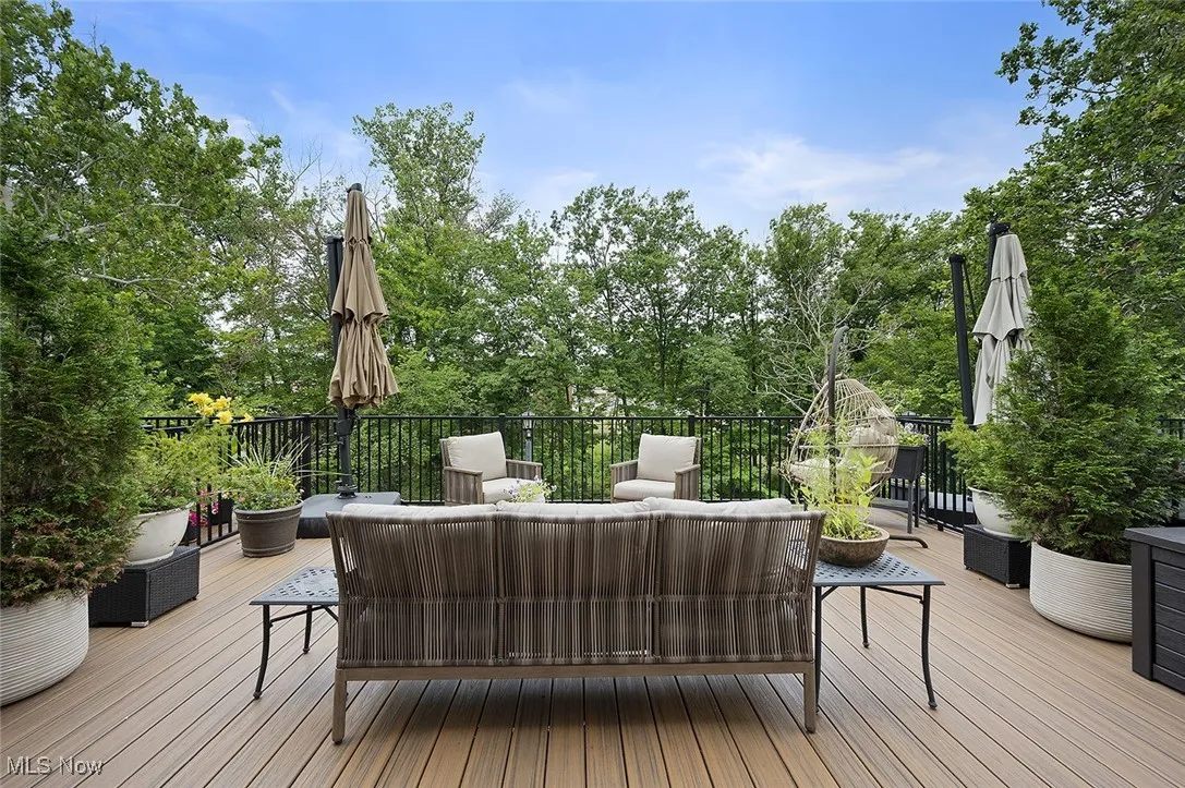 Wooden terrace with an outdoor living space and view of scattered trees