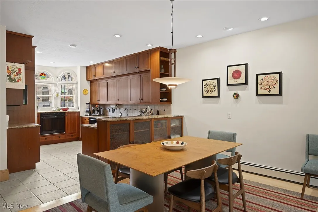 Dining room featuring recessed lighting, light tile patterned floors, and a baseboard radiator
