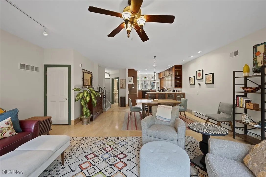 Living room featuring light wood-type flooring, a ceiling fan, and recessed lighting