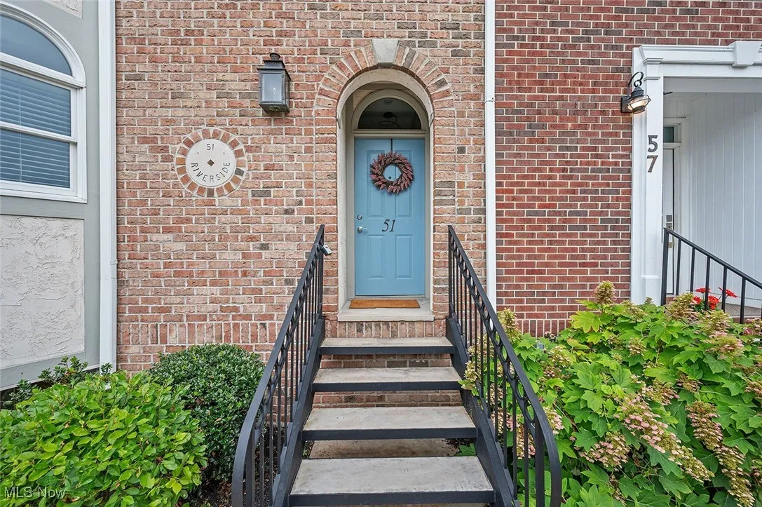 Property entrance featuring brick siding