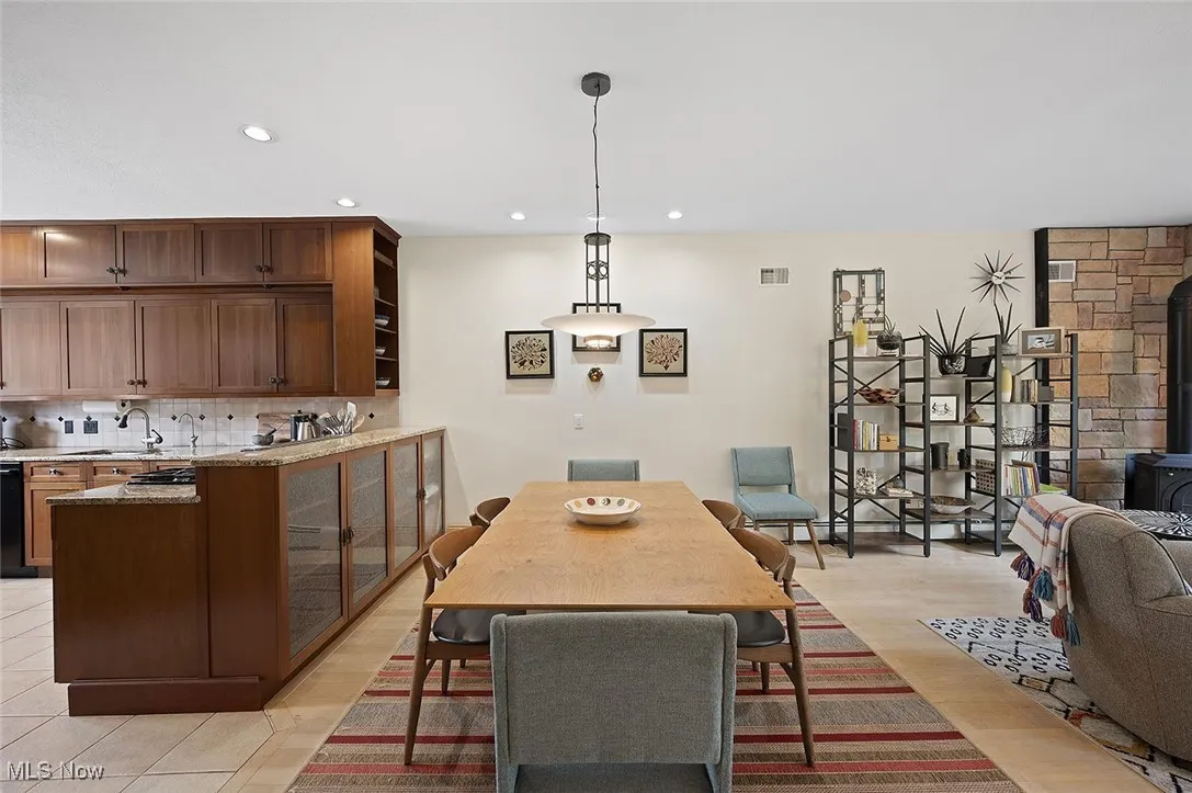 Dining room featuring a wood stove and recessed lighting