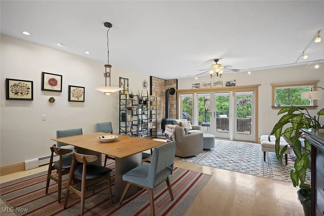 Dining area featuring a ceiling fan, wood finished floors, baseboard heating, rail lighting, and recessed lighting