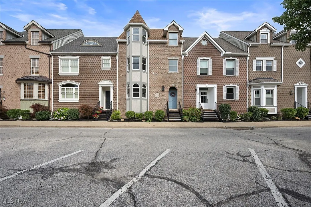 View of front of home featuring brick siding and uncovered parking