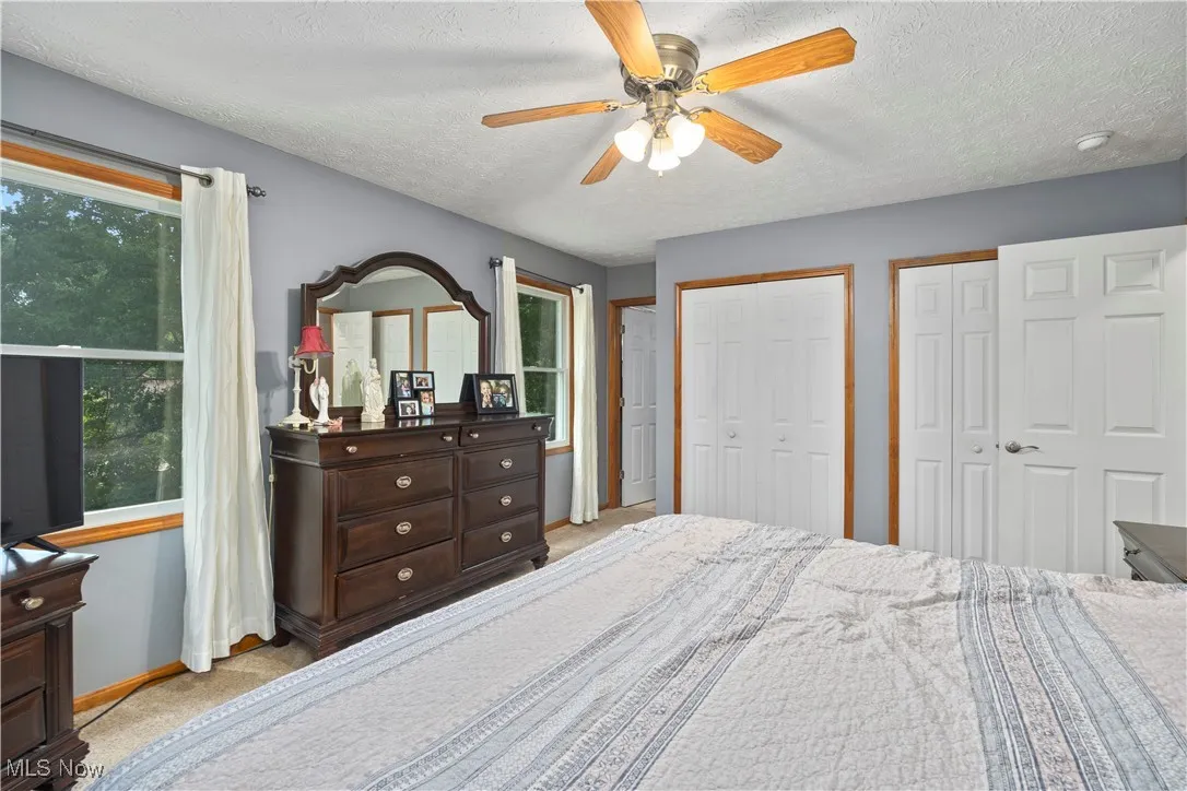 Master bedroom featuring 2 closets and full bathroom