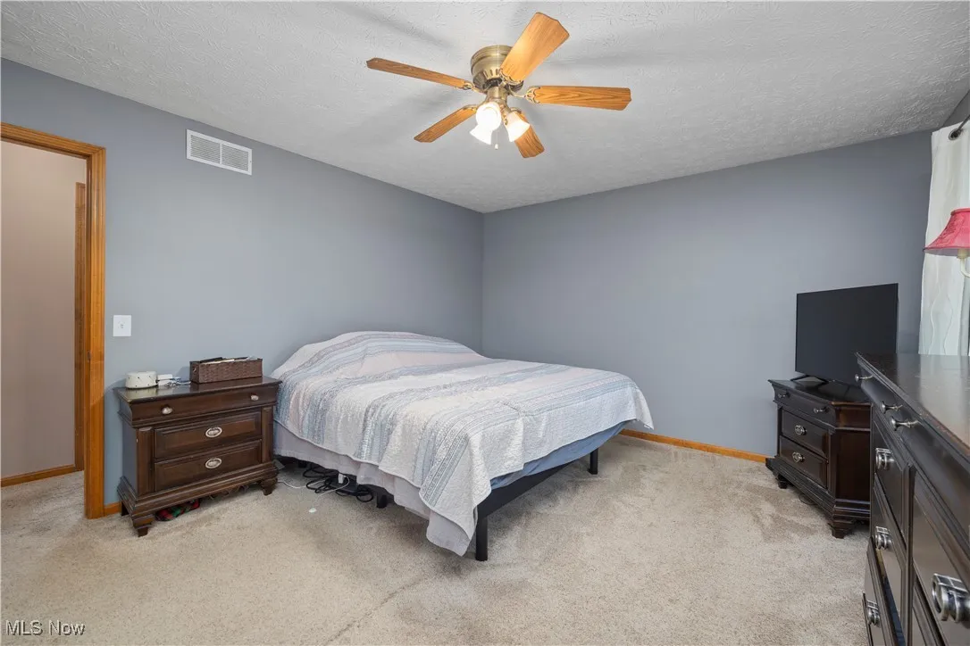 Master bedroom featuring 2 closets and full bathroom
