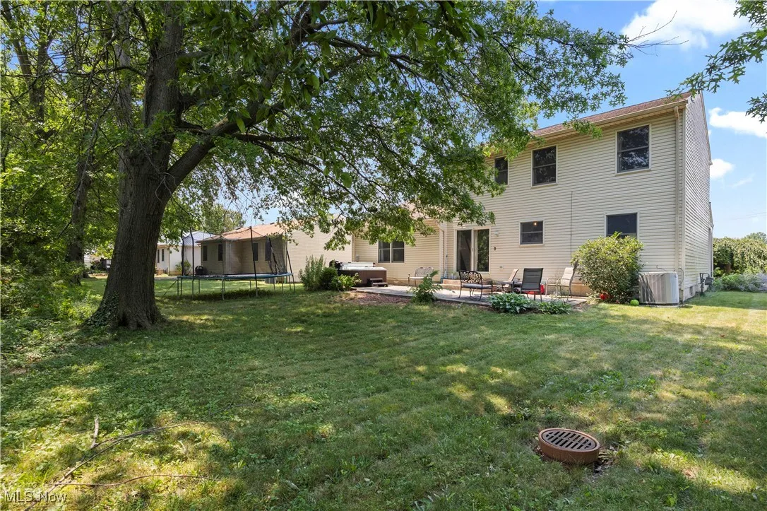 Backyard comes with a hot tub and a stamped concrete patio