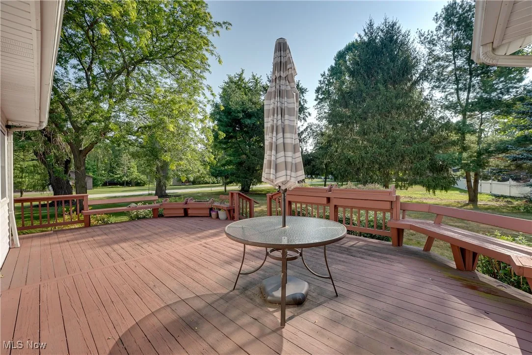 Wooden terrace with view of wooded area