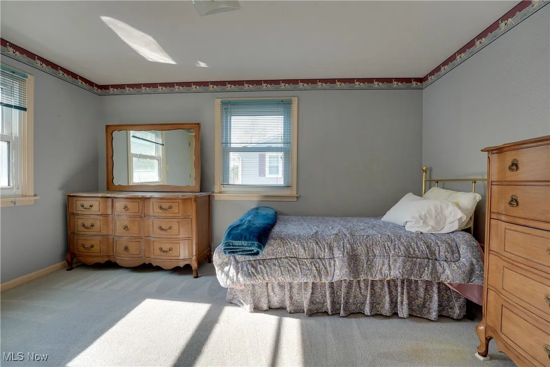 Carpeted bedroom featuring baseboards