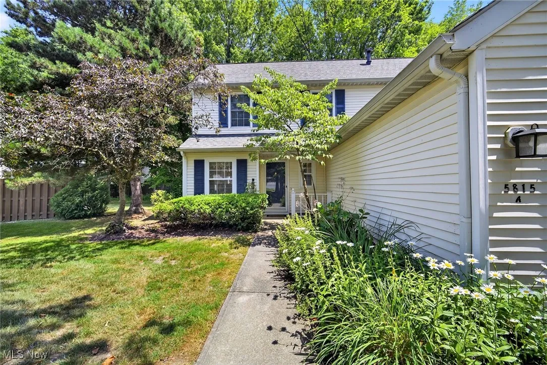 Doorway to property with a shingled roof
