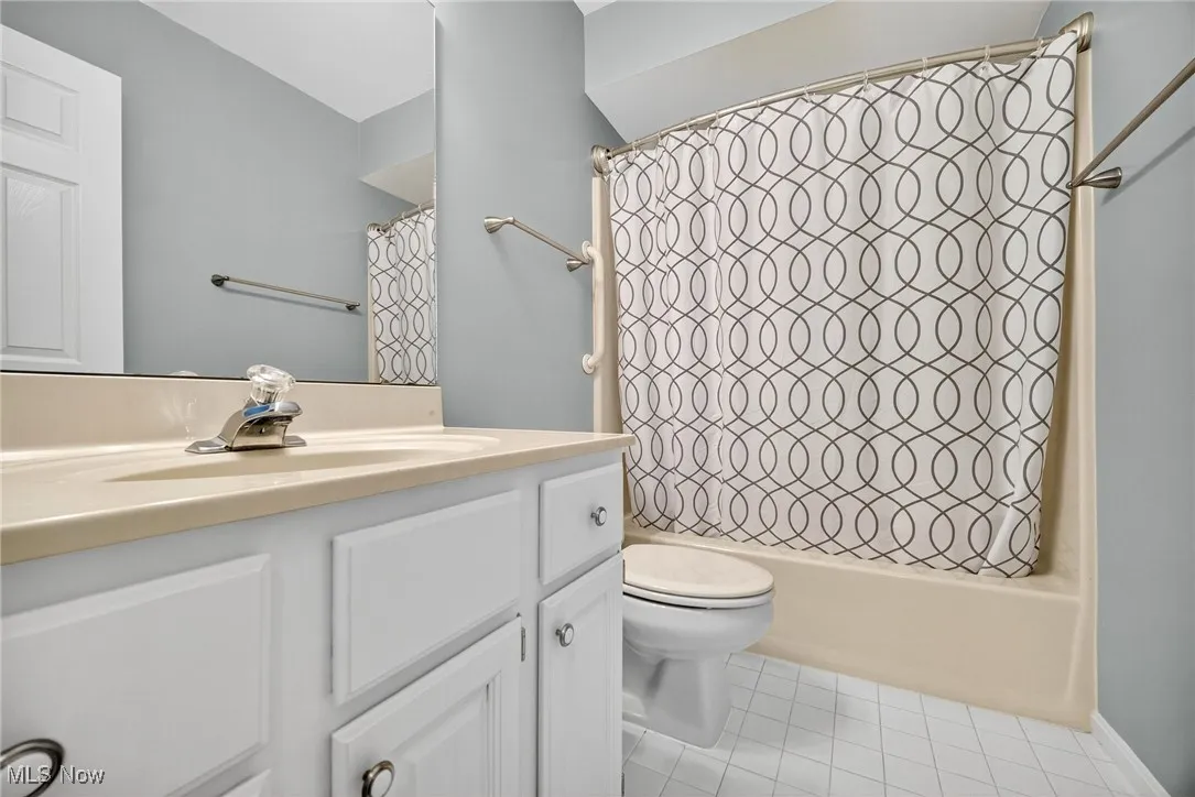 2nd floor Full bathroom with vanity, shower / tub combo with curtain, and tile patterned flooring