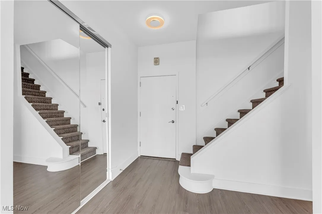 Entryway featuring stairway and wood finished floors