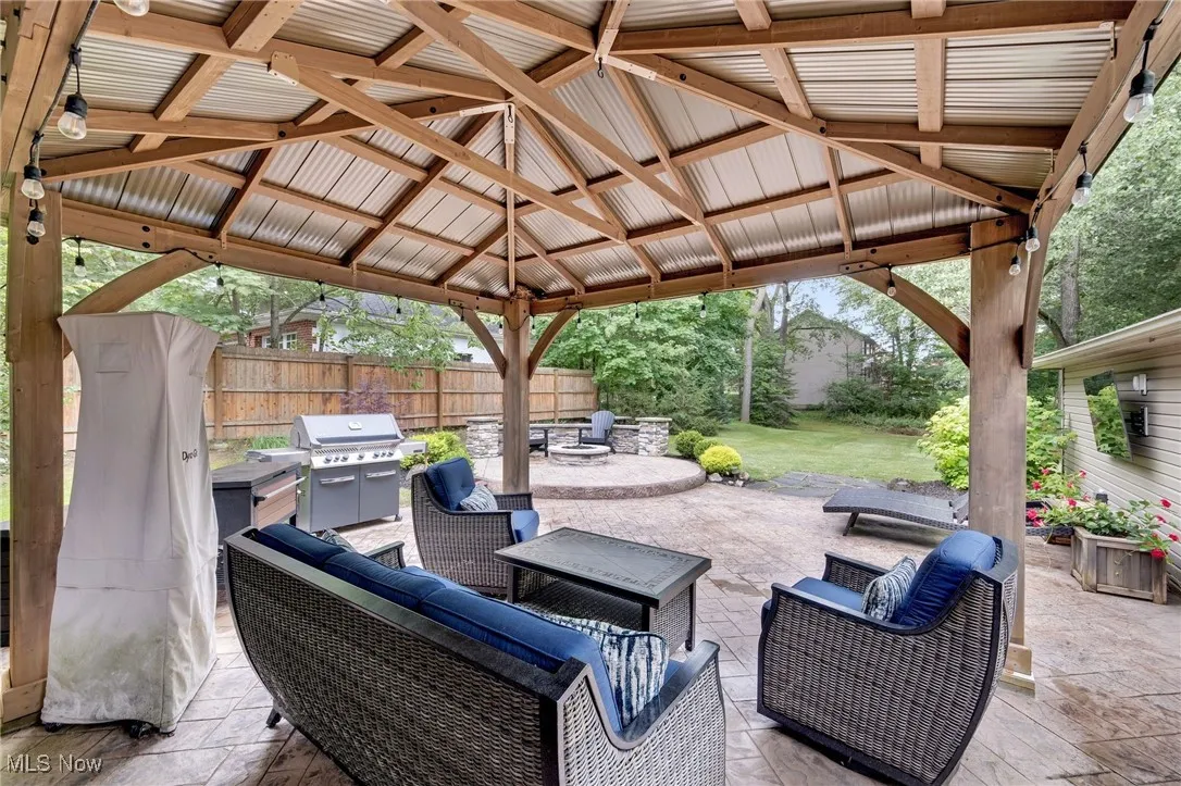 View of patio / terrace featuring a gazebo, an outdoor living space with a fire pit, and a grill