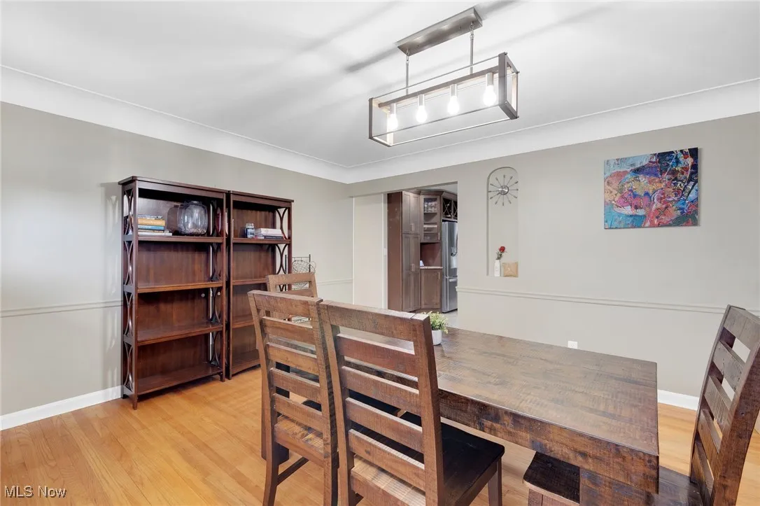 Dining room featuring light wood-style flooring and baseboards