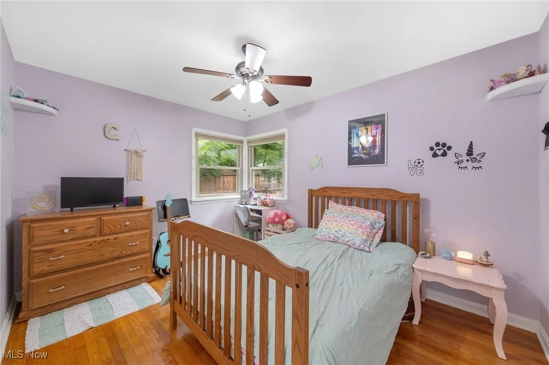 Bedroom with wood finished floors and a ceiling fan