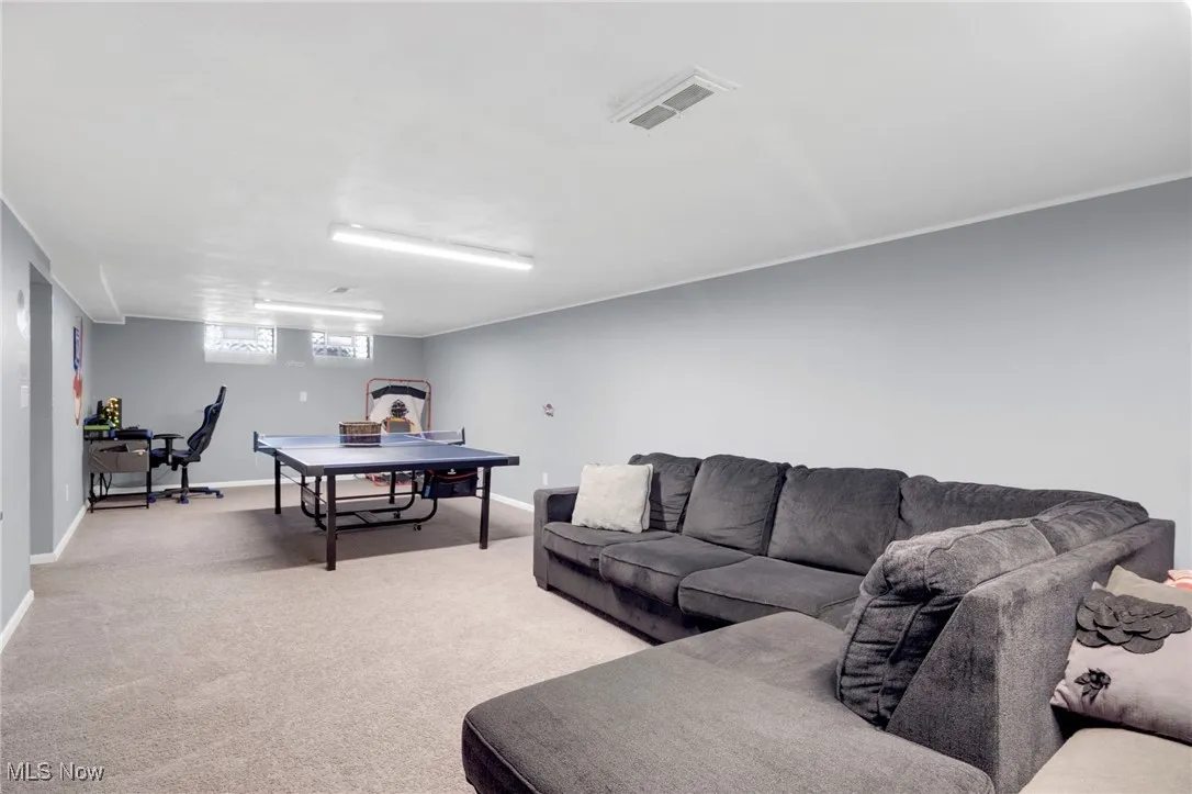 Living area with light carpet and baseboards