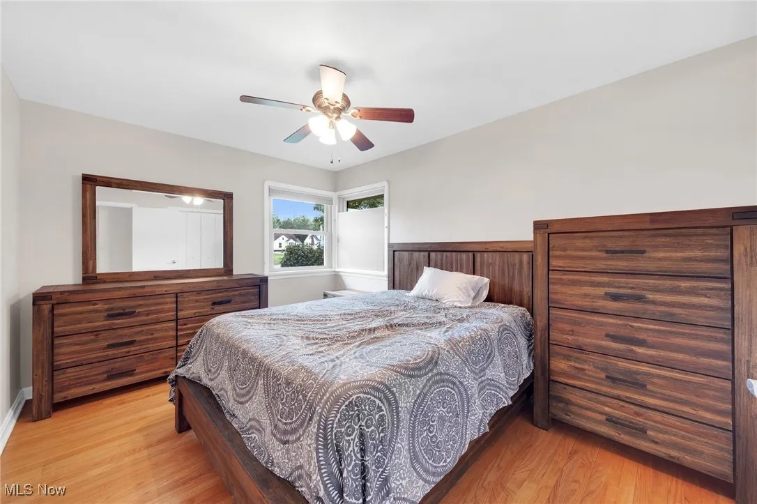 Bedroom with light wood finished floors and a ceiling fan