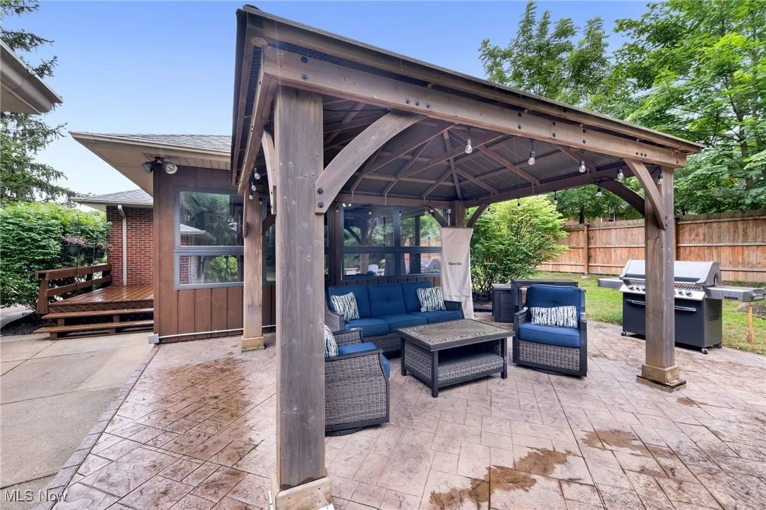 View of patio / terrace featuring a gazebo, an outdoor living space, and a grill