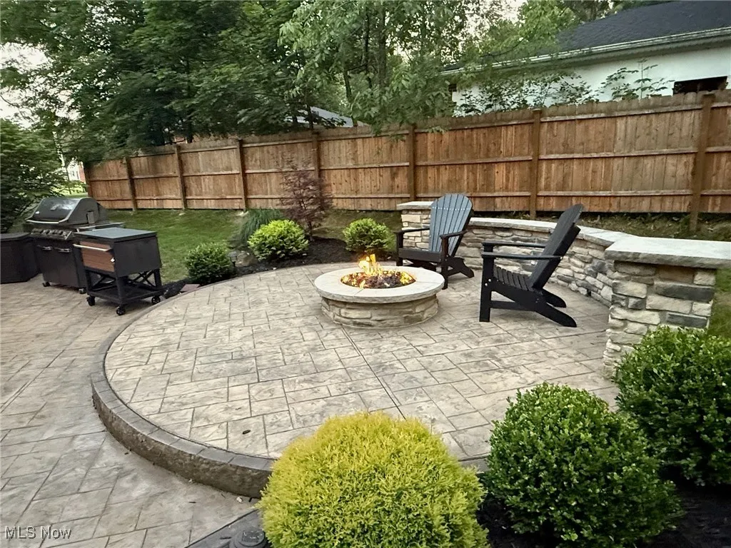 View of patio featuring a fire pit and a grill