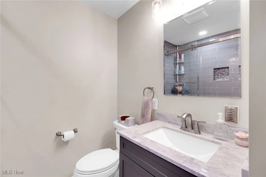 Bathroom featuring vanity and tiled shower