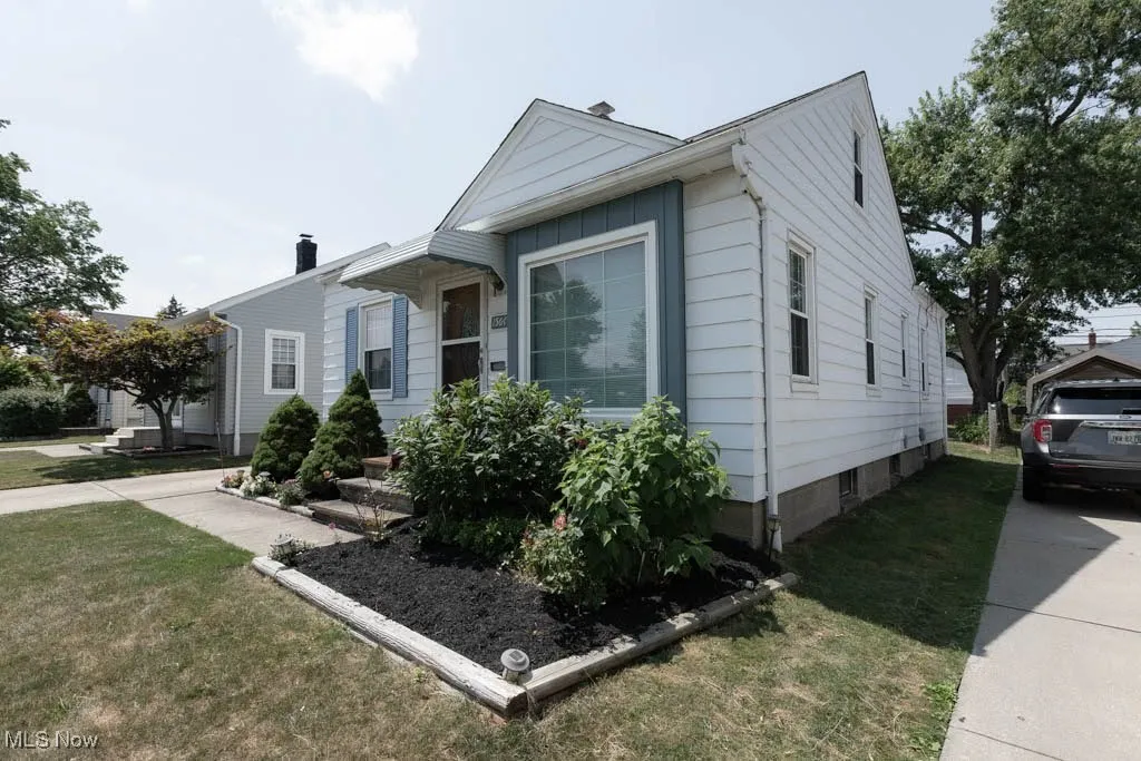 Bungalow-style house with a front yard and a chimney