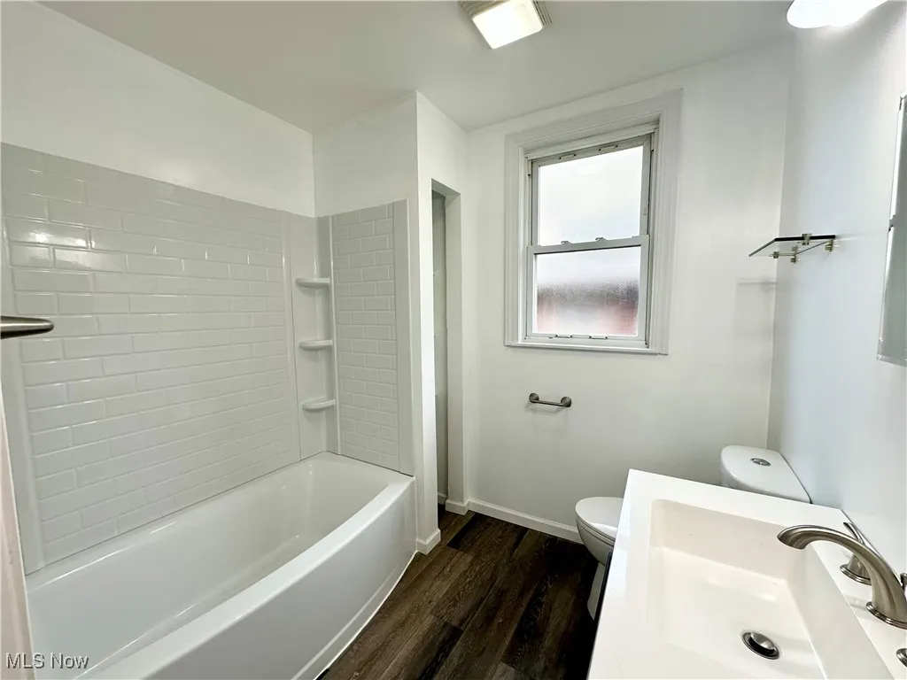First floor Bathroom featuring shower / bath combination, vanity, and toilet