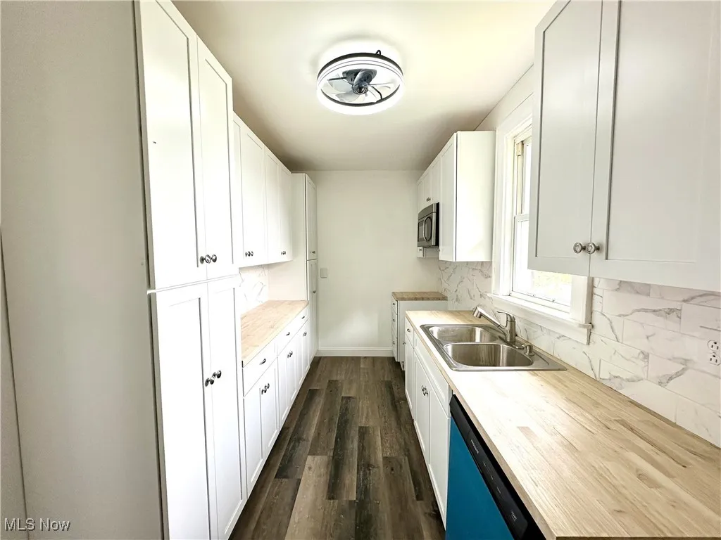 Kitchen with dishwasher, microwave, sink, and cabinetry