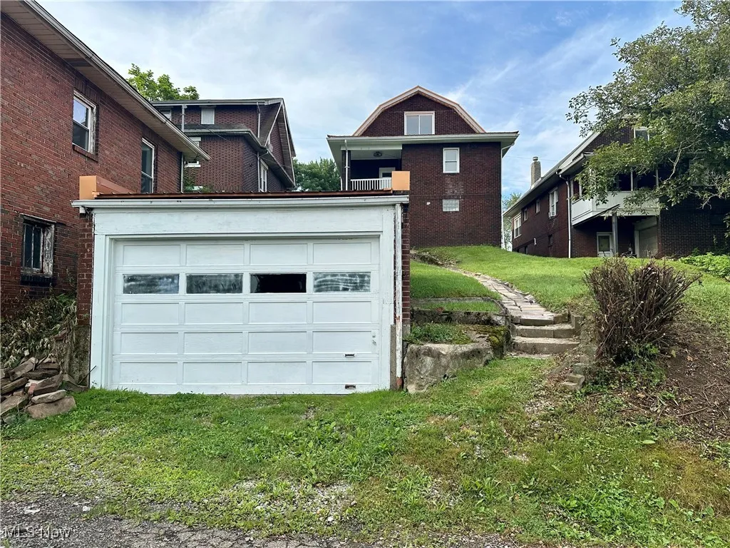 Back view of home with a garage