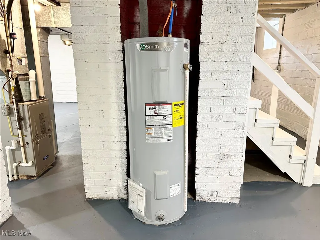 Basement featuring new electric water heater and heating unit
