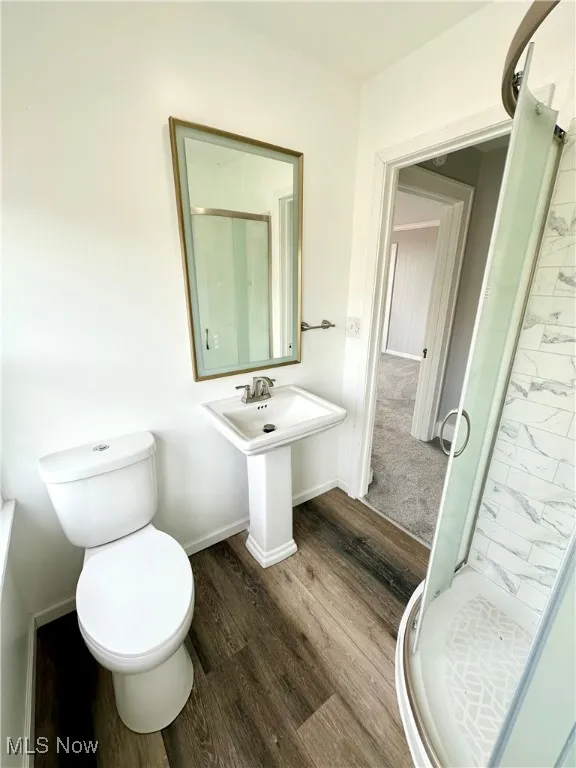 Second floor Bathroom with a stall shower and wood finished floors