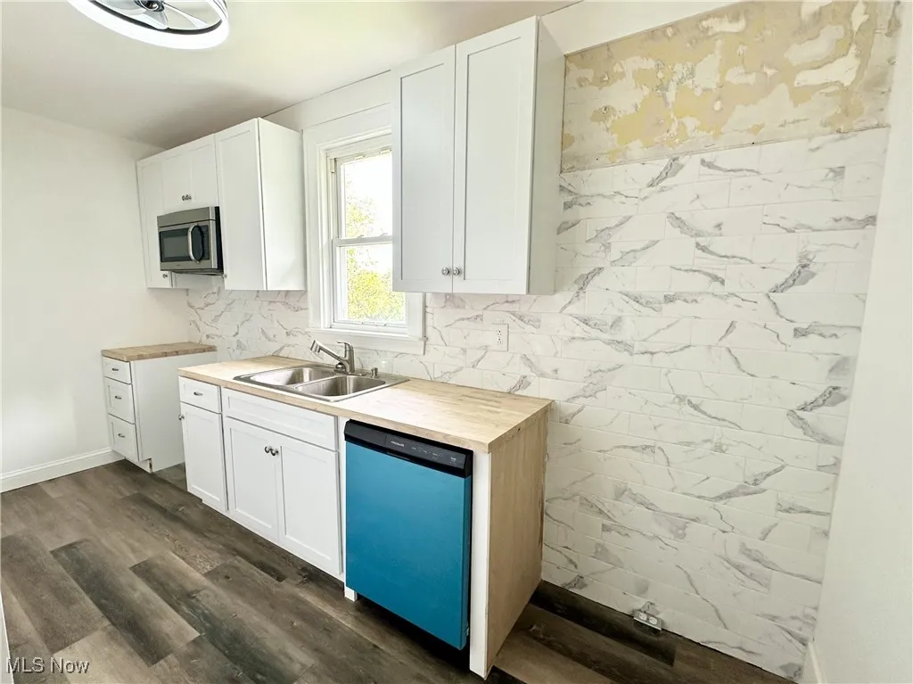 Kitchen featuring dishwasher, microwave, and cabinets - upper cabinet to be installed