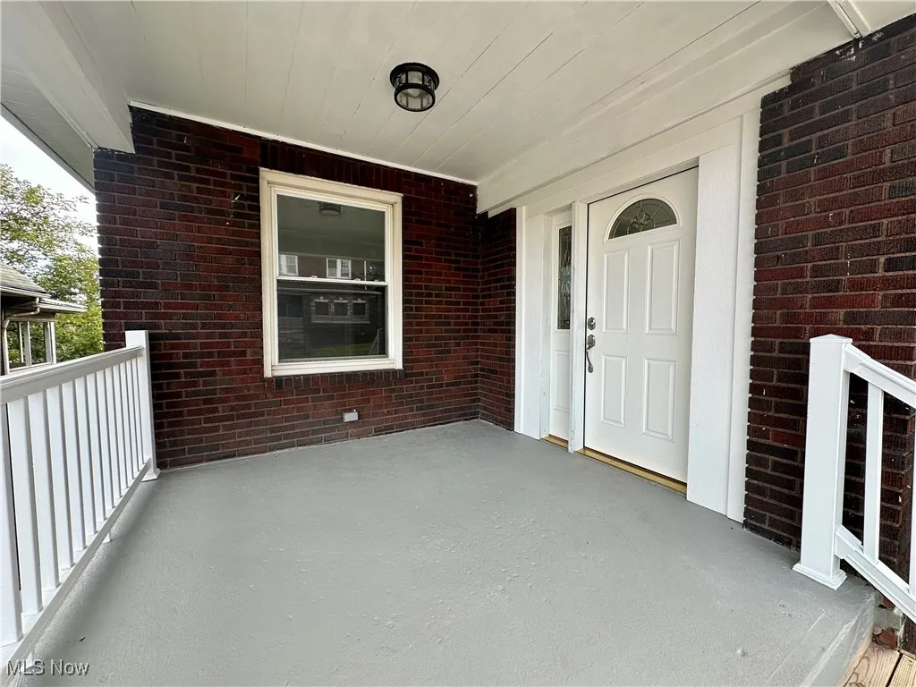 Entrance to home with a covered front porch