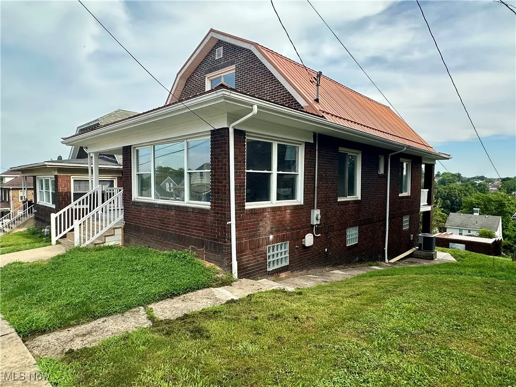 Side view of home with a yard