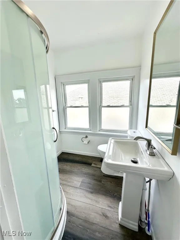 Second floor Full bath featuring a shower stall and wood finished floors