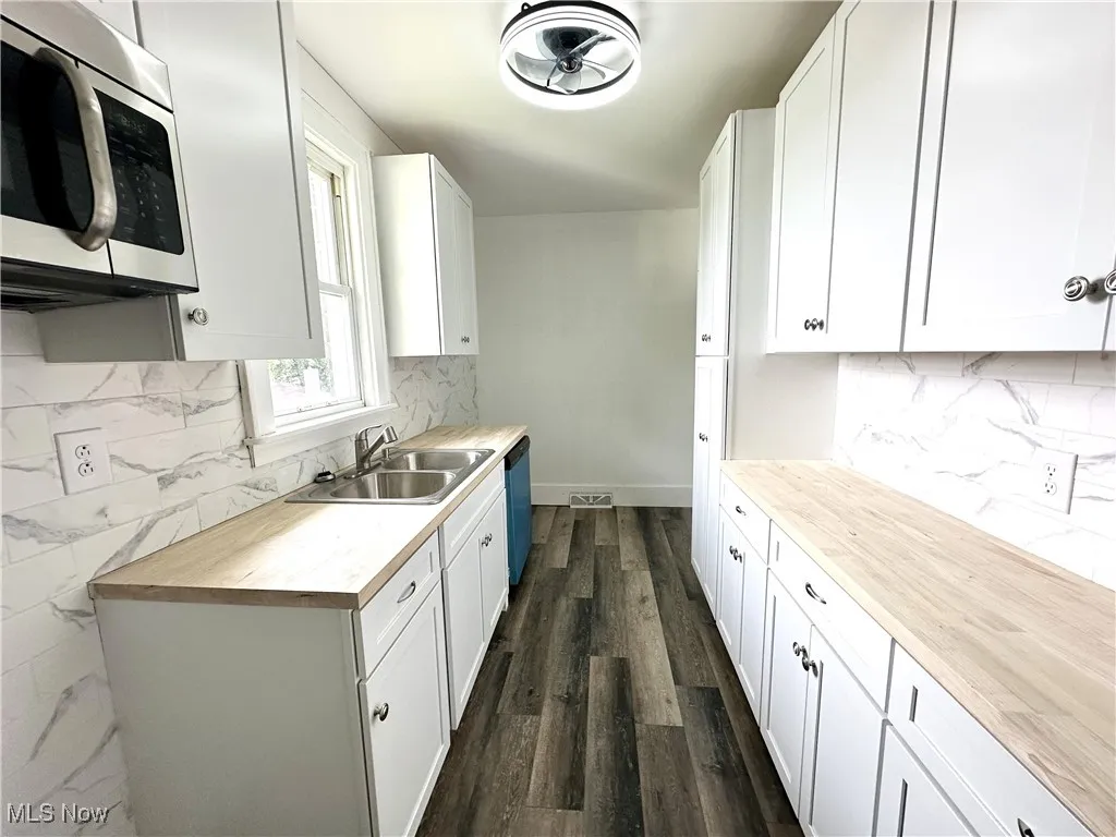 Kitchen with microwave, and cabinets