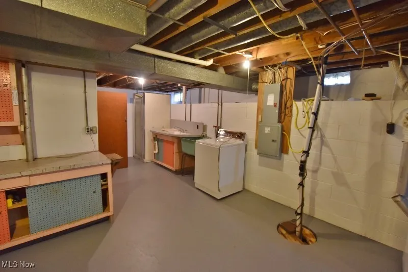 The basement offers plenty of space for storage and a work bench