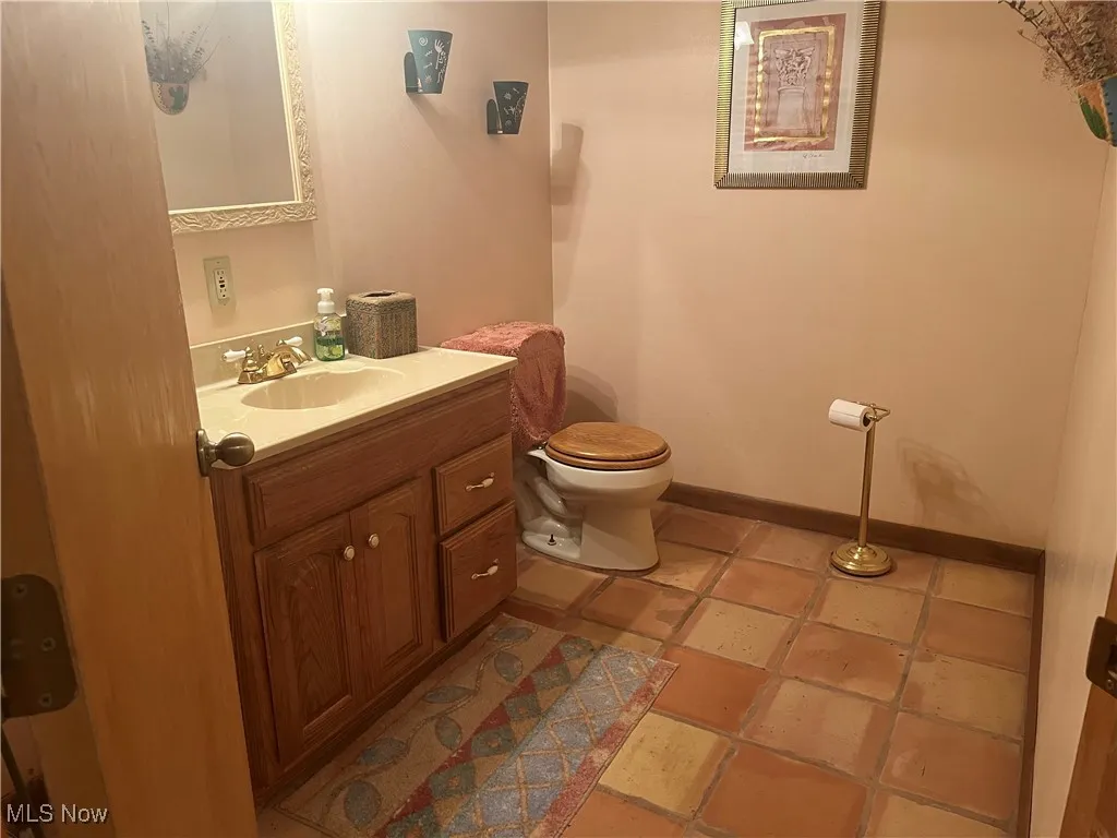 Half bathroom with toilet and vanity