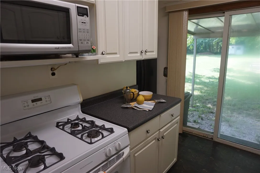 White galley kitchen, gas range.