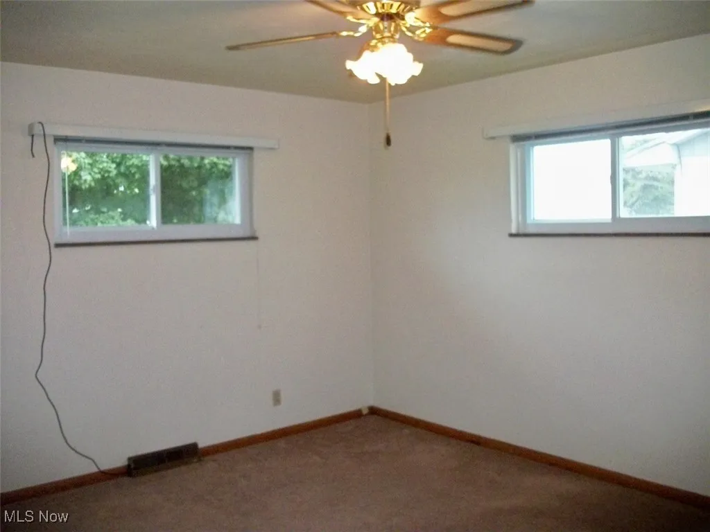 with a ceiling fan and carpet floors