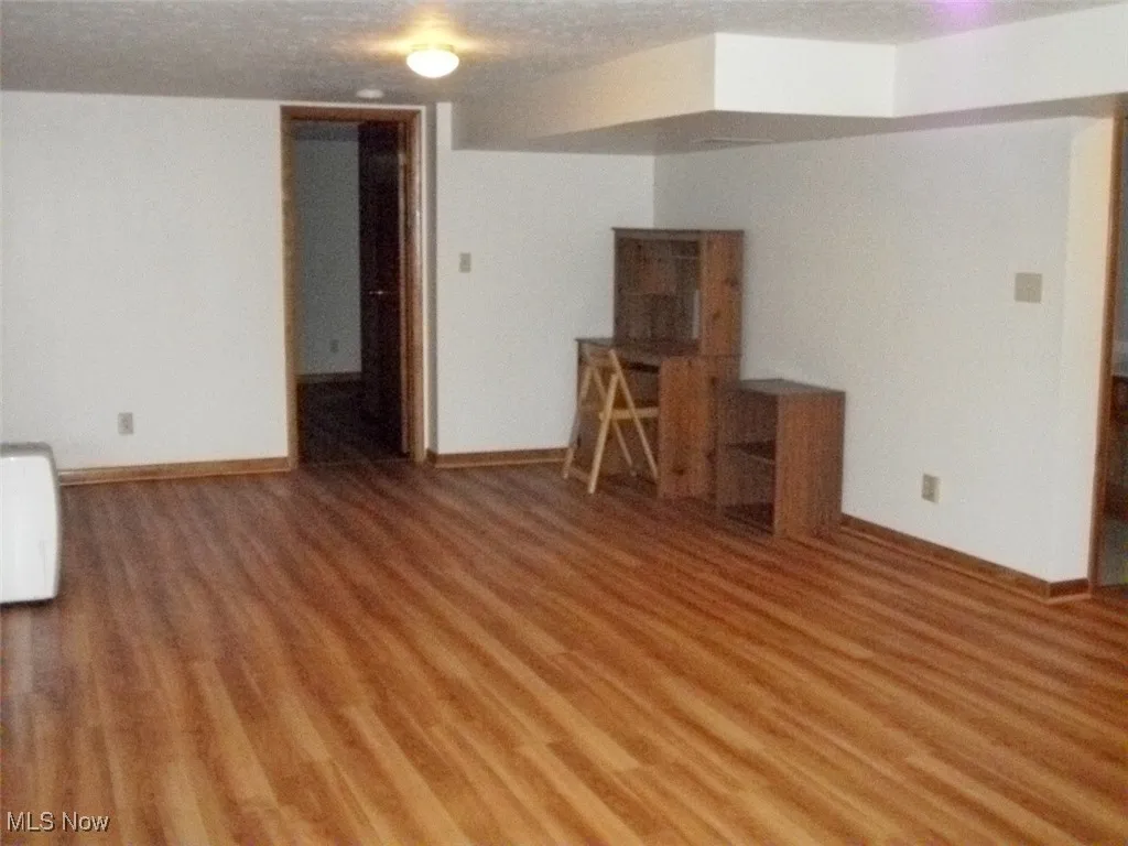 Family/rec room featuring light wood-style flooring and baseboards