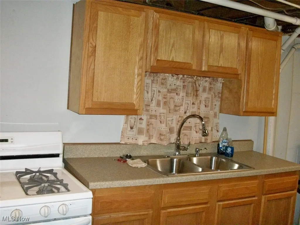 Summer downstairs Kitchen featuring gas range gas stove and light countertops