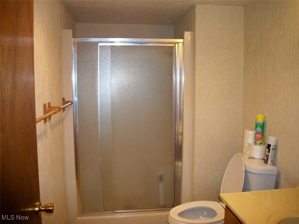 Full bath featuring vanity and a standup shower stall