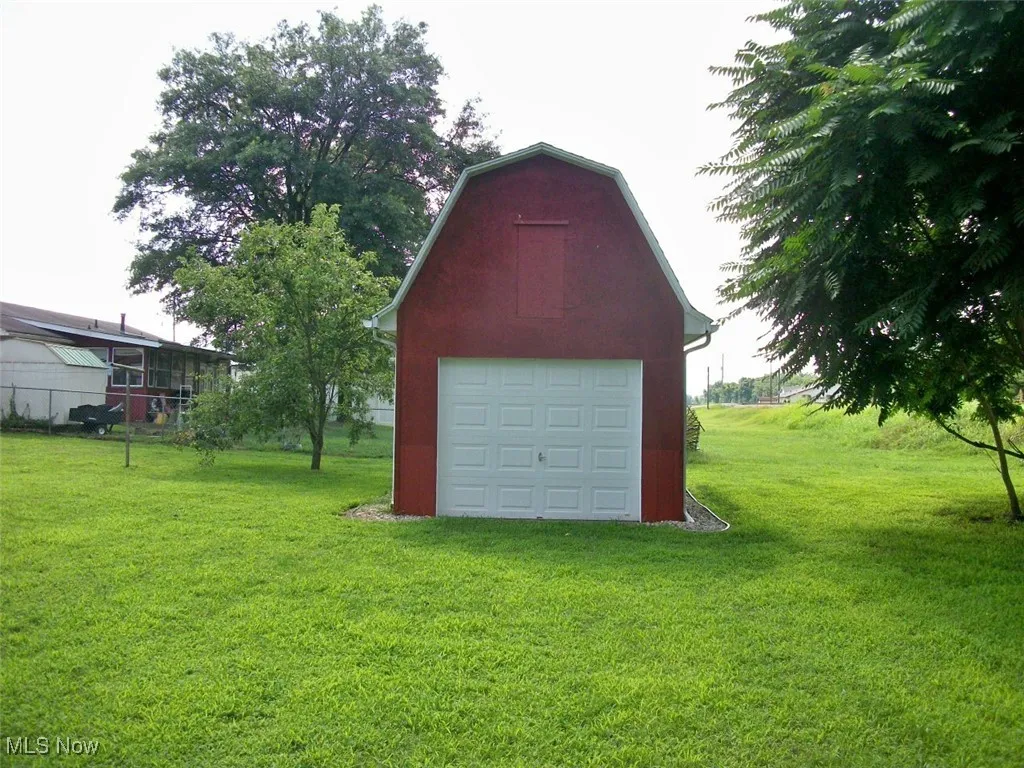 Storage shed with garage door & second floor storage.